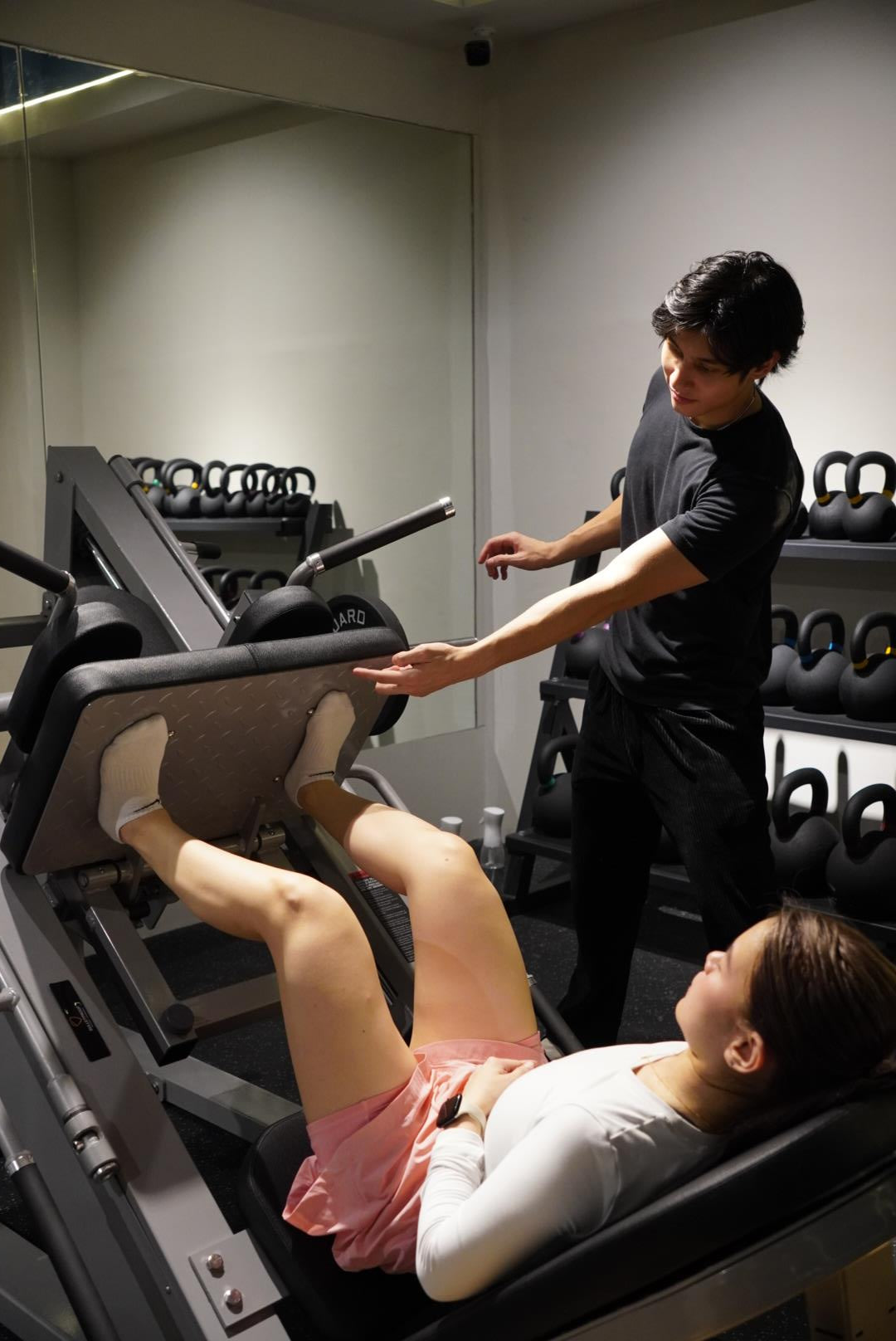 A Performance Specialist coaching an athlete through a lift at Bulletproof Quezon City