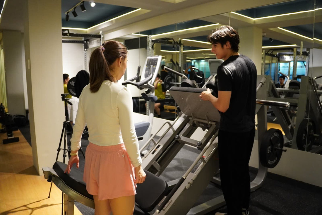 A Performance Specialist coaching a client through a leg press at the Bulletproof clinic